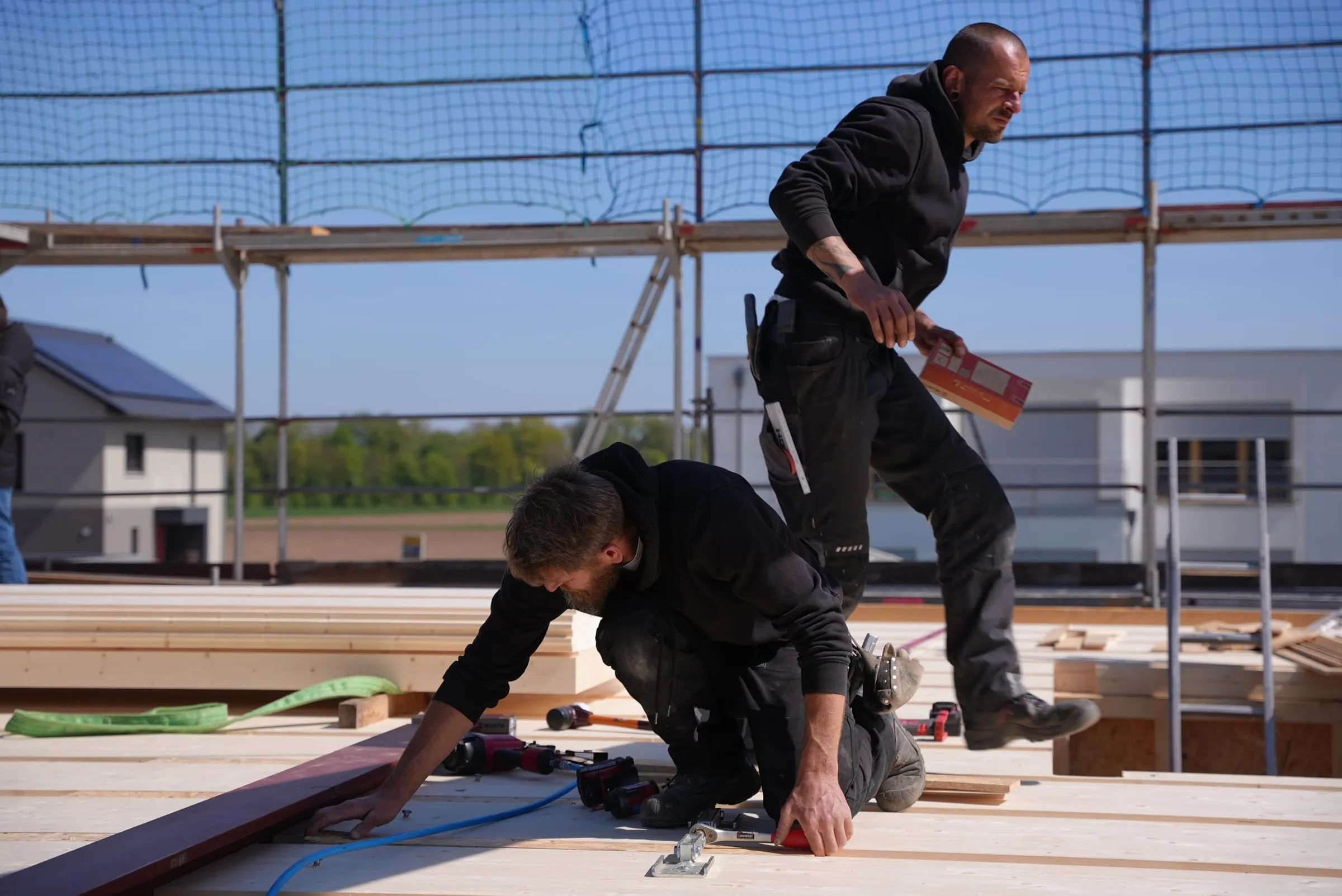 Team der Sawatzki GmbH setzt vorgefertigte Dachelemente gemeinsam auf der Baustelle